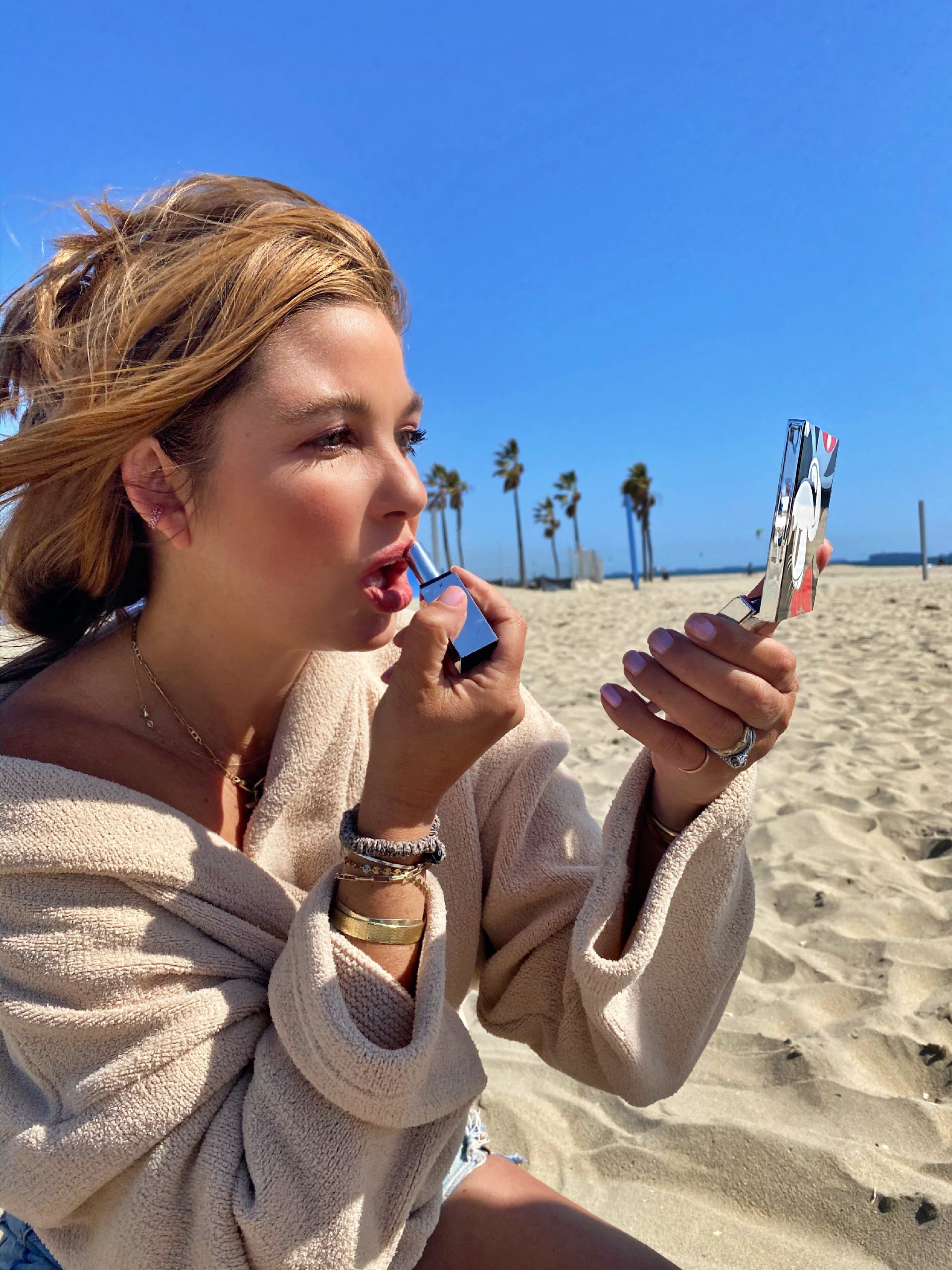 applying makeup at the beach