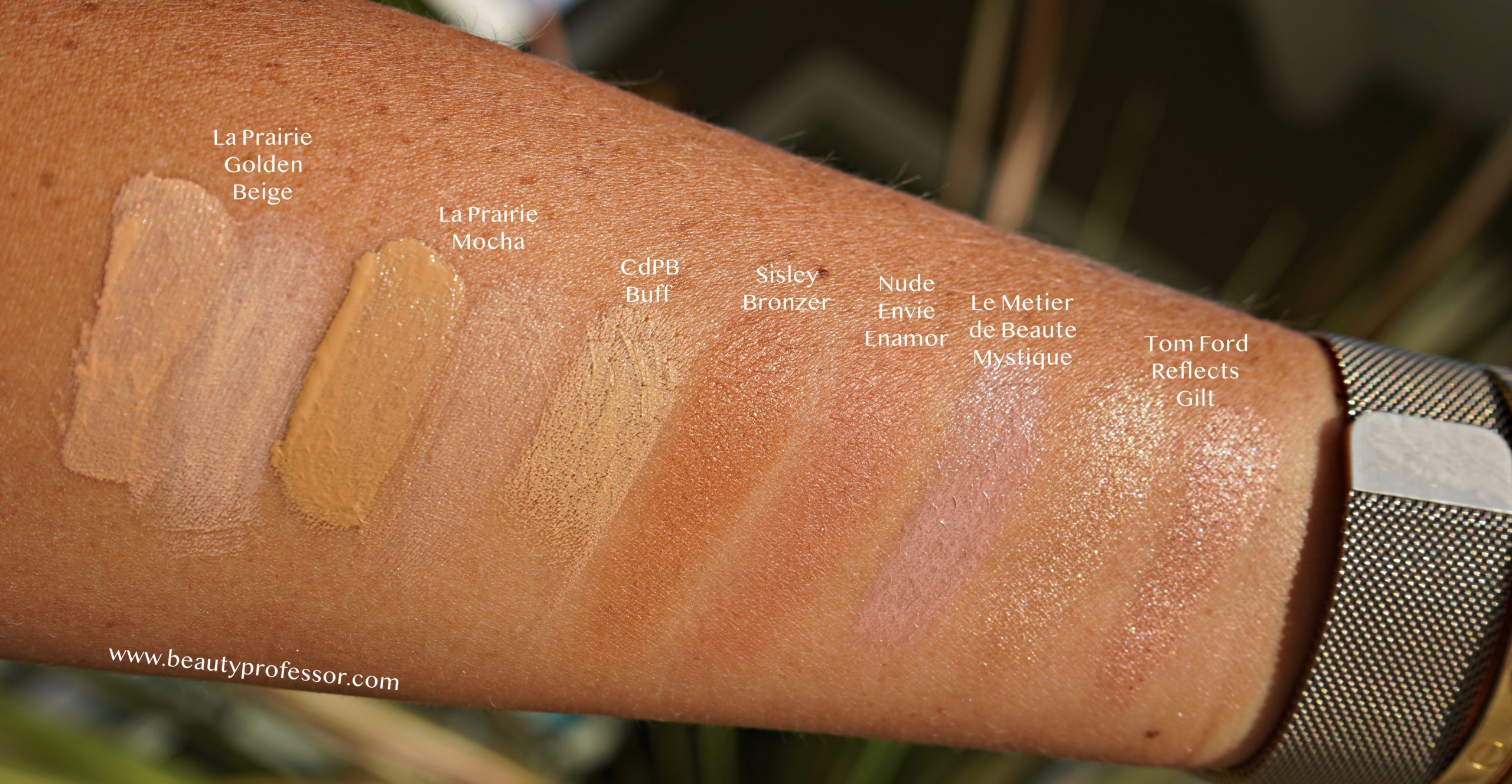swatches of base and face makeup on an arm