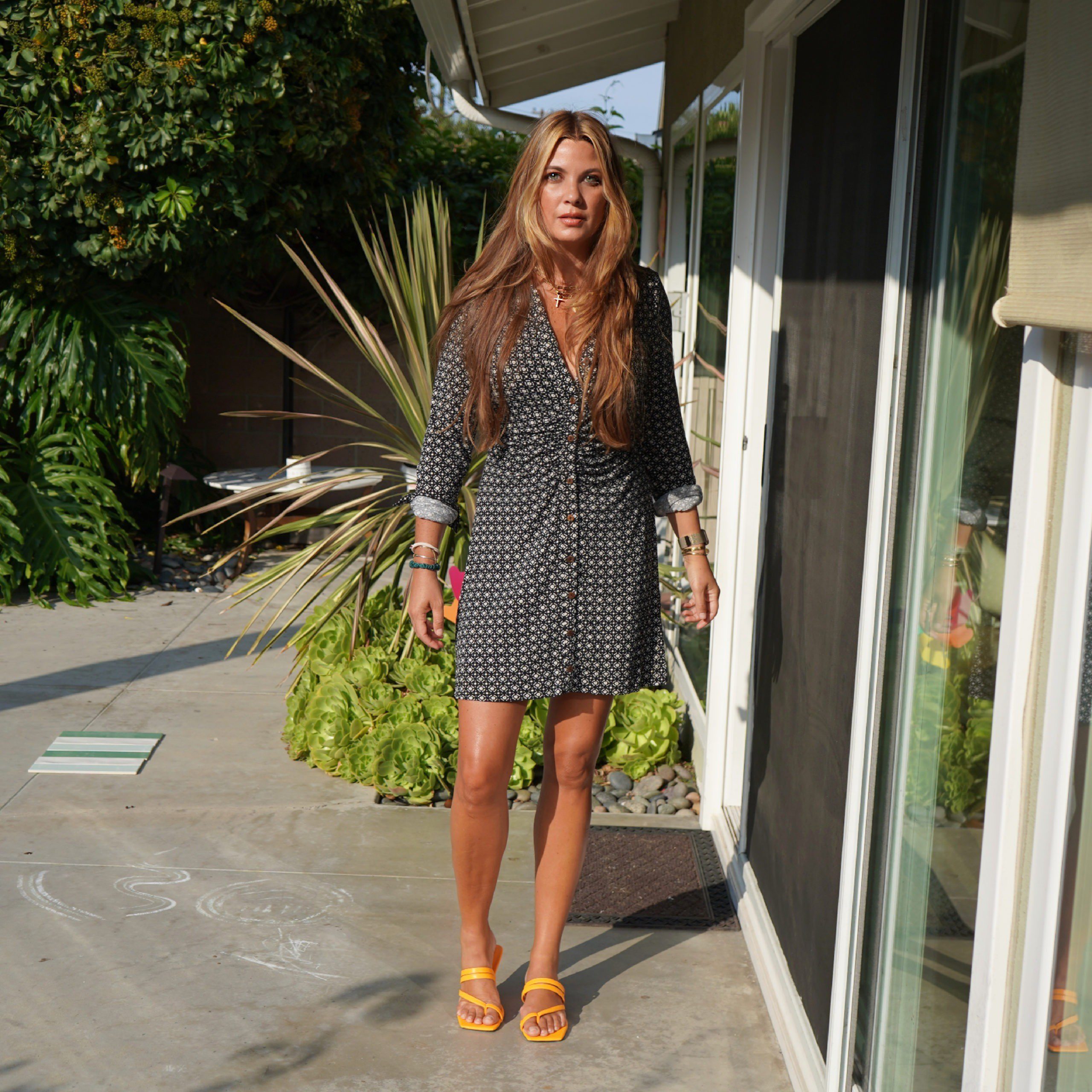 walking and wearing dress and yellow sandals