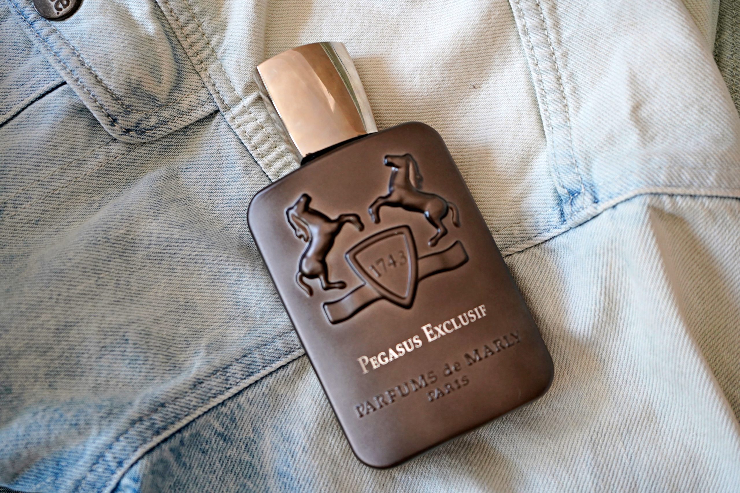 perfume on top of a denim jacket