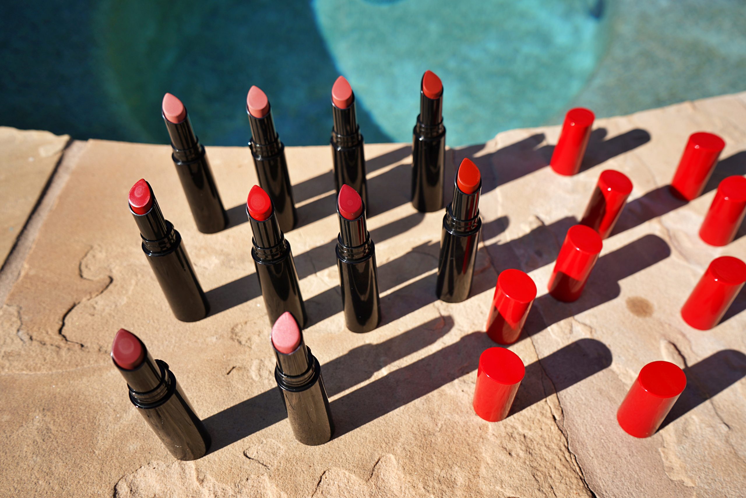 open lid Giorgio Armani lip power swatches at the pool side