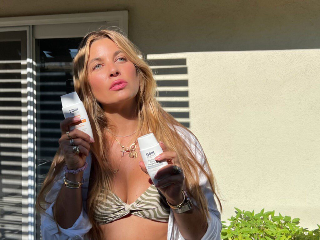 woman holding isdn sunscreen for Sunscreen Routine