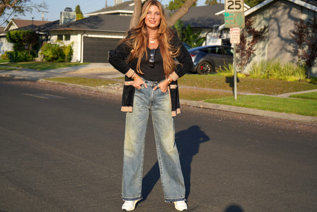 Beauty Professor Blogger Rachel Anise Wegter sharing wearing her Nordstrom Anniversary Sale picks: woman in black top, sweater, jeans, and white sneakers