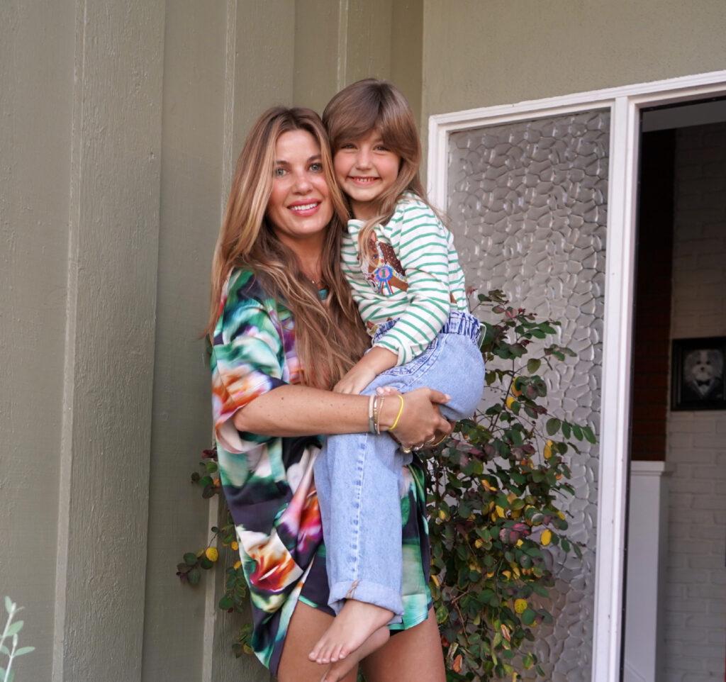 Beauty Professor Blogger Rachel Anise Wegter carrying her daughter