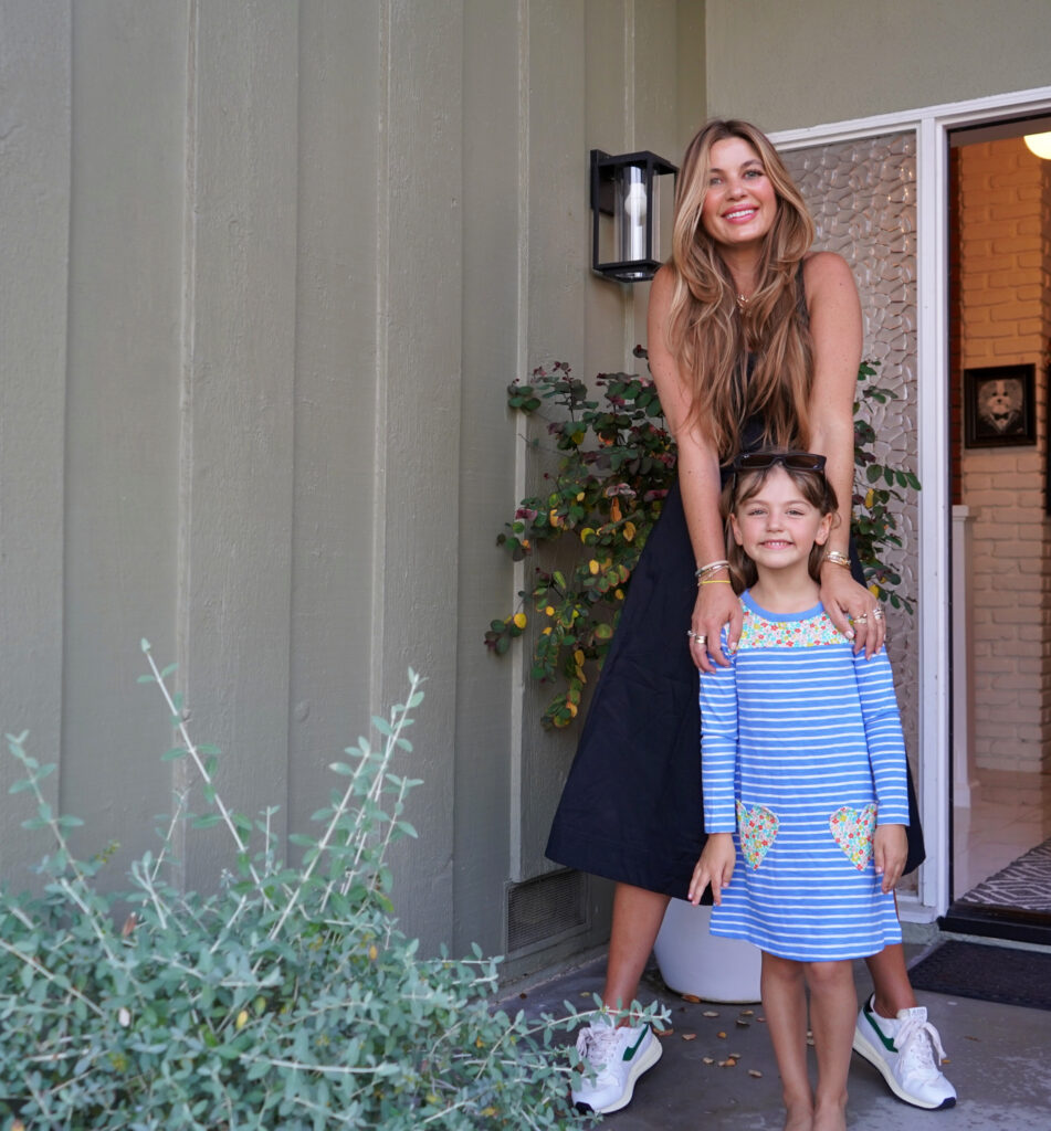 Beauty Professor Blogger Rachel Anise Wegter with their Nordstrom Anniversary Sale picks: wearing midi dress by Veronica Beard and the Autrey Reelwind Sneakers a striped while her daugher is wearing heart pocket frock (for Joey Elle) by Boden Ray-Ban rectangular sunglasses.